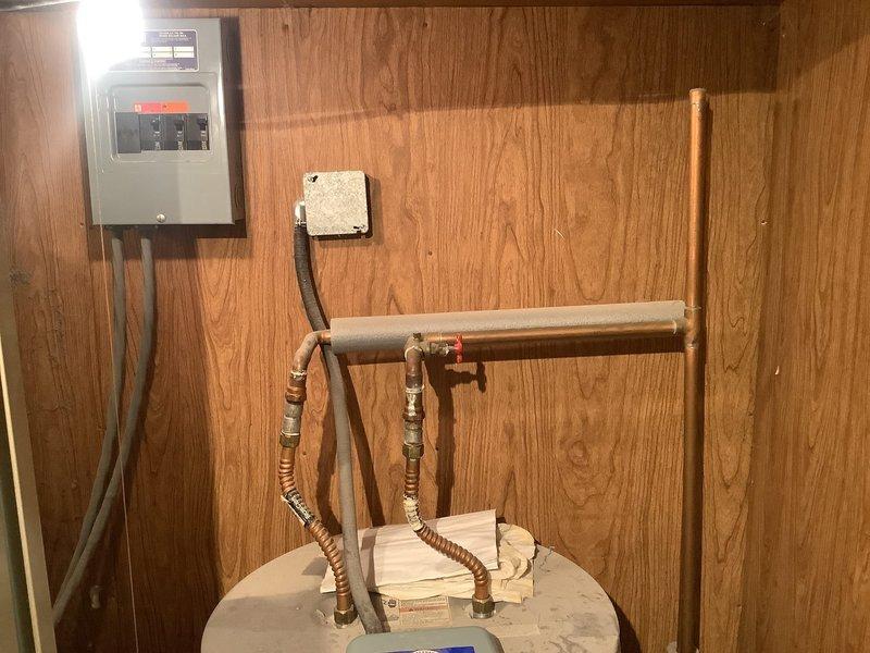 Responded to service call for 10-year-old Whirlpool natural gas tanked water heater displaying "start up failure" error on control unit. Customer reported previously replacing control board, which only functioned for one day before indicating upper element failure. Upon inspection, diagnosed faulty upper heating element and control board communication issue. Verified proper electrical connections, tested element continuity, and assessed digital control system functionality. Inspected copper supply lines, pressure relief valve, and gas connections for proper operation and safety compliance.