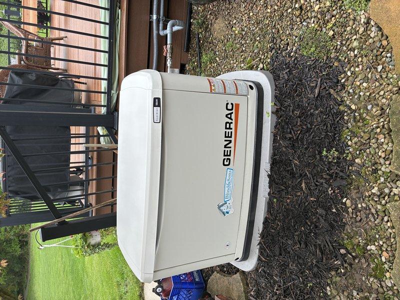 Performed maintenance inspection on residential Generac standby generator following customer report of indicator light remaining illuminated and unit shutting down prematurely during recent power outage. Conducted visual inspection of exterior-mounted unit, verified proper installation on mulch bed with adequate clearance and ventilation. Assessed generator control panel status lights and reviewed recent operational history. Inspected fuel supply lines, electrical connections, and exhaust system for proper function. Documented unit condition with photographs showing one-year-old generator in good physical condition with all manufacturer labels intact. Explained normal operational indicator light behavior to customer and verified automatic transfer switch functionality. Unit tested successfully with no immediate faults detected during service call.