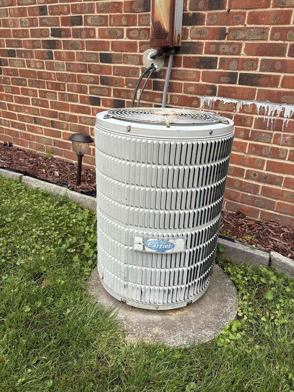 Completed comprehensive HVAC system evaluation for furnace and air conditioning replacement estimate. Documented existing equipment including indoor ductwork configuration and outdoor condensing unit positioned on concrete pad against building exterior. Measured supply ductwork dimensions and assessed current system components to provide accurate replacement specifications and senior discount pricing options.
