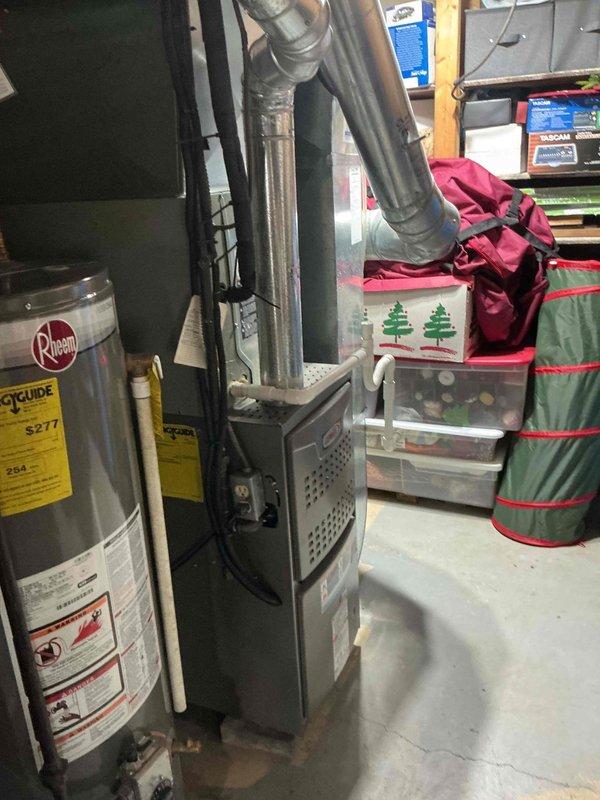 Completed routine MVP cooling maintenance on 10-year-old residential air conditioning system. Performed standard inspection of furnace and ductwork, verified proper operation of HVAC equipment, and documented system condition with photos showing basement installation with metal ductwork and insulation in satisfactory working order.