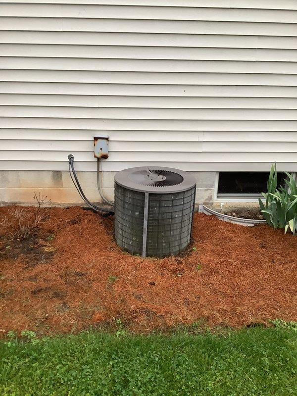 Completed full HVAC system installation including 80% efficiency furnace, air conditioning unit, and humidifier. Installed new gray furnace unit in basement mechanical room with proper venting and ductwork connections. Mounted outdoor AC condenser unit on exterior foundation with fresh mulch bed, ran refrigerant lines and electrical conduit through exterior wall with junction box. Integrated humidifier into system for whole-home humidity control. All equipment properly positioned, secured, and connected per manufacturer specifications. System tested and operational.
