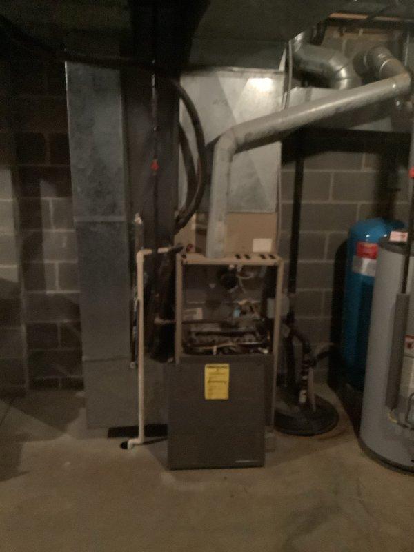 Completed full HVAC system installation including 80% efficiency furnace, air conditioning unit, and humidifier. Installed new gray furnace unit in basement mechanical room with proper venting and ductwork connections. Mounted outdoor AC condenser unit on exterior foundation with fresh mulch bed, ran refrigerant lines and electrical conduit through exterior wall with junction box. Integrated humidifier into system for whole-home humidity control. All equipment properly positioned, secured, and connected per manufacturer specifications. System tested and operational.