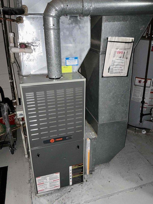 Completed comprehensive estimate for furnace and air conditioning system replacement at residential property. Assessed existing Trane furnace installation in basement mechanical room, including evaluation of galvanized ductwork configuration, plenum assembly, and current system specifications. Documented equipment labels, safety warnings, and technical specifications on existing unit. Inspected associated HVAC infrastructure including electrical panel connections, copper refrigerant lines, flexible ductwork routing, and structural mounting considerations. Photographed complete system layout to support replacement quote preparation. Provided detailed equipment replacement proposal for new furnace and air conditioning system installation.