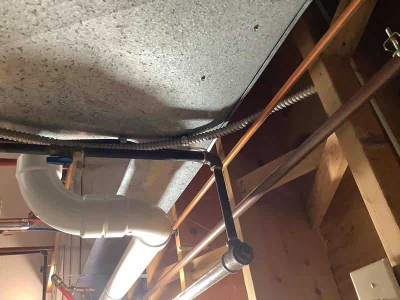 Provided comprehensive quote for water heater replacement at the property. Conducted thorough assessment of existing tanked water heater unit, surrounding plumbing connections, and installation area including overhead piping and structural clearances. Documented current system configuration with detailed photographs showing workspace preparation, existing plumbing infrastructure, ceiling-mounted supply and drain lines, and available access points for replacement unit installation.