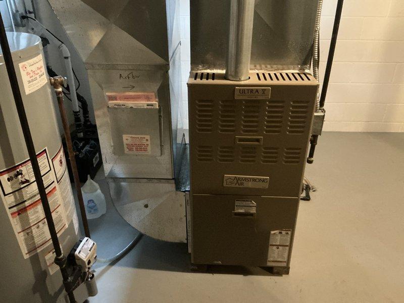 Responded to no cooling complaint and performed comprehensive assessment of existing HVAC system. Evaluated Armstrong Air furnace unit with Ultra V component in basement mechanical room, inspecting ductwork, electrical connections, and overall system configuration. Assessed outdoor condenser unit positioned in landscaped area adjacent to home foundation, examining unit condition, placement, and operational status. Provided detailed replacement estimate for complete HVAC system upgrade to restore cooling functionality and improve system efficiency.