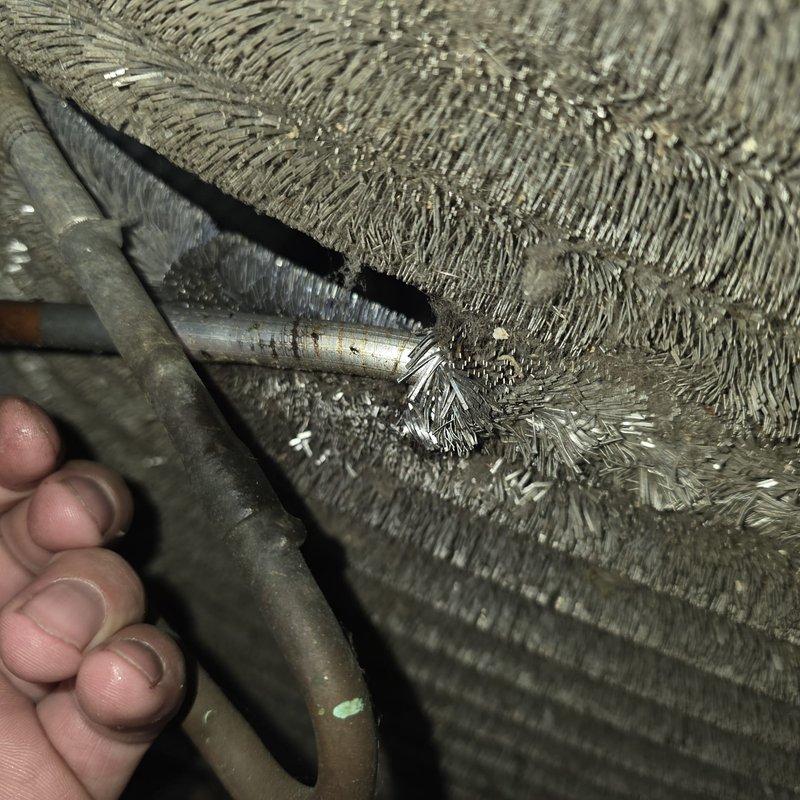 # HVAC Maintenance - Cooling Service

Completed routine MVP cooling maintenance visit on 10-year-old system. Upon inspection, discovered extensive frost and ice crystal buildup throughout the flexible aluminum ductwork, indicating a significant refrigerant leak or airflow restriction issue. The frost formation was uniform and dense across all visible duct surfaces, including metallic couplings and connectors. Additionally, identified severe rust and corrosion on copper refrigerant piping, with heavy oxidation and reddish-brown discoloration present. Documented conditions with photographic evidence showing compromised ductwork insulation and deteriorated piping infrastructure. System requires immediate attention to address refrigerant loss, restore proper airflow, and prevent further degradation of copper lines. Recommended follow-up service to repair or replace affected components and restore system to optimal operating condition.