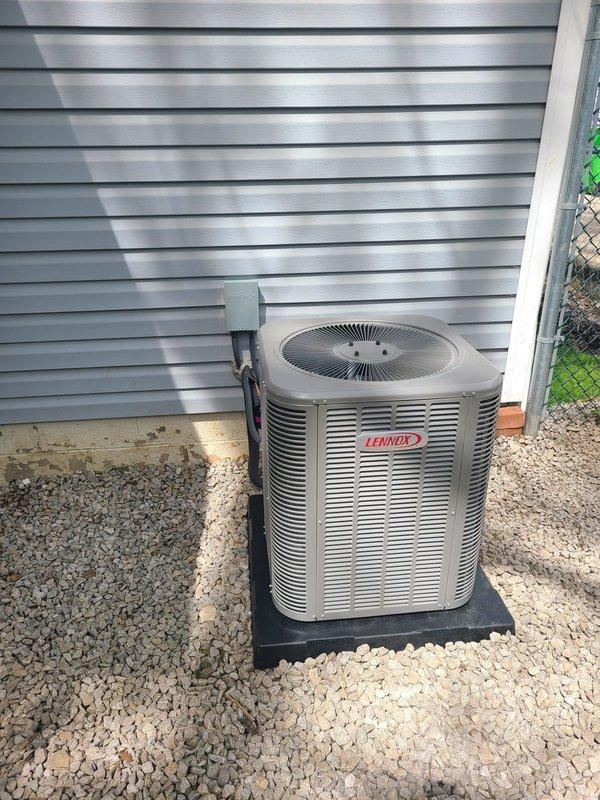 # HVAC Installation Complete

Successfully completed installation of new Lennox outdoor condensing unit and evaporator coil system paired with existing Trane furnace. Positioned condenser on composite pad with gravel base for proper drainage and vibration dampening. Ran refrigerant lines and electrical conduit through exterior wall, ensuring proper insulation and weatherproofing. Connected evaporator coil to furnace plenum in basement mechanical room with appropriate ductwork modifications. Installed white PVC condensate drain line vertically from coil assembly. Verified all refrigerant connections are secure and leak-free. Tested electrical connections at disconnect and confirmed proper voltage. System commissioned, charged to manufacturer specifications, and verified operational parameters including airflow, superheat, and subcooling values within acceptable ranges.