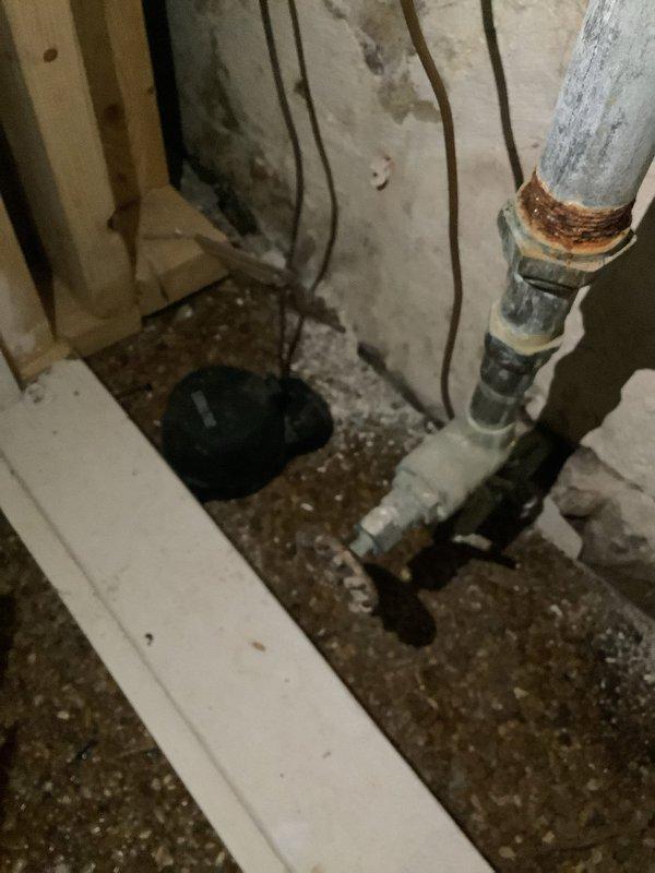 Conducted on-site evaluation for automatic shut-off valve installation in 1925-era residential property. Assessed existing plumbing infrastructure in basement utility area, including water heater connections and main water supply lines. Documented current piping configuration featuring combination of white PVC, copper, and black iron pipes to determine optimal placement for automatic shut-off valve system. Provided estimate for installation of emergency water shut-off valve to protect aging plumbing system from potential water damage.