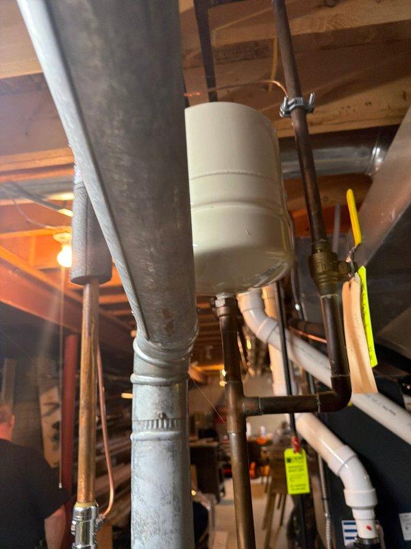 Provided estimate for replacement of a 2017 manufactured 40-gallon gas water heater exhibiting active leakage. Assessed existing Rheem Classic Professional series unit installed in basement utility area with standard top-mount brass connections for hot and cold water supply lines, temperature and pressure relief valve, and gas control assembly. Documented current installation configuration including copper supply piping, PVC venting system, expansion tank mounting, and floor positioning to ensure accurate replacement specifications and code compliance for new equipment installation.