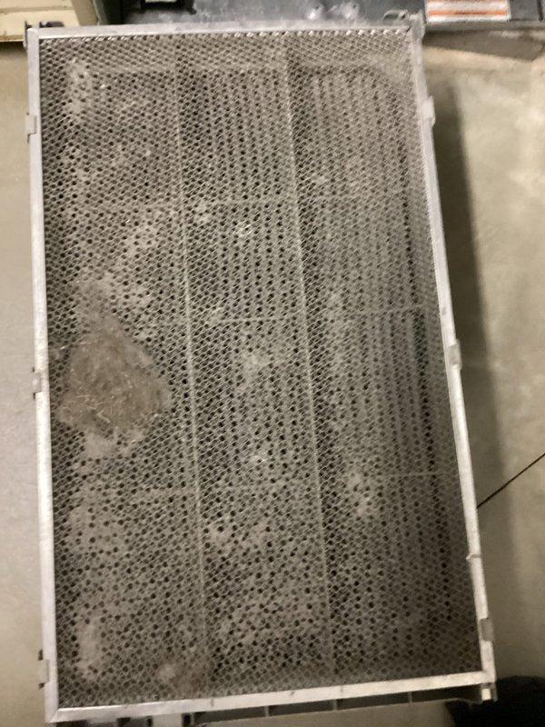 Completed MVP recurring cooling maintenance visit on 12-year-old HVAC system. Inspected air handler and condensing unit, documenting heavily soiled air filter with significant dust and debris accumulation throughout mesh surface, which was restricting airflow. Photographed filter condition and overall system installation including exposed ductwork, refrigerant lines, and basement mechanical area with proper insulation and PVC drainage piping. System operational at time of inspection with all components accessible for routine service.