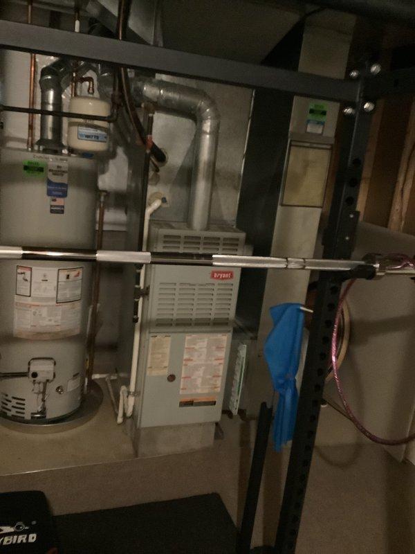 Conducted comprehensive assessment of existing HVAC system including Bryant furnace and air conditioning unit with frozen evaporator coil. Evaluated aged equipment condition, documented current mechanical room configuration with ductwork, water heater proximity, and electrical panel placement. Provided estimate for complete HVAC system replacement including both furnace and air conditioning components due to equipment age and operational failure.