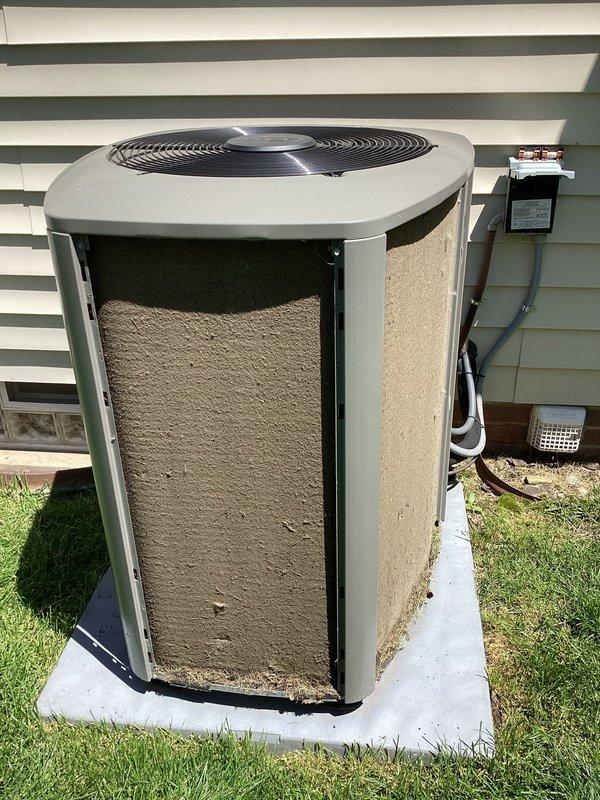 Completed scheduled preventive maintenance cooling visit on 3-year-old residential air conditioning system. Performed comprehensive inspection of outdoor condenser unit and indoor evaporator coil components. Noted significant accumulation of dirt and debris on condenser unit's interior filter material, which was restricting proper airflow and reducing system efficiency. Inspected evaporator coil fins and heat exchanger surfaces, verifying proper condition and clearances. Verified electrical connections at disconnect box and checked refrigerant line insulation integrity. System operational upon completion of maintenance procedures.