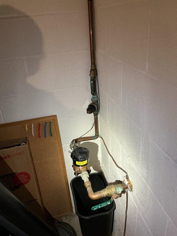 Responded to service call for low water pressure issues in the farthest bathroom and knocking water lines following recent water heater replacement. Inspected plumbing system including water softener, supply lines, and shower fixtures. Evaluated water pressure at multiple fixtures throughout the residence to diagnose pressure loss. Examined copper piping, connections, and pressure relief components for restrictions or air in the lines. Assessed water softener operation and bypass valve positioning to rule out equipment-related pressure reduction. Investigated concerns regarding water heater venting as potential contributing factor to pressure issues. Verified proper installation of new water heater connections and supply lines. Addressed water hammer causing knocking sounds in plumbing system.