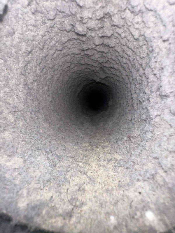 Completed dryer vent cleaning service with heavily accumulated lint and dust buildup throughout the duct system. Removed significant debris from interior vent surfaces and thoroughly cleaned the exhaust pathway from the dryer to the exterior termination point. Documentation photos captured the extent of the initial buildup and the cleaning process, with exterior work performed on the patio area where the vent terminates.