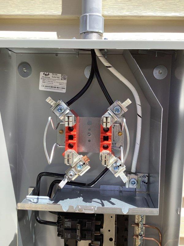 Completed 100-amp electrical service upgrade including installation of exterior disconnect switch as mandated by 2023 National Electrical Code requirements. Upgraded main service panel with new circuit breakers, installed proper grounding system with bonding connections, and ran new service conductors from exterior disconnect to interior distribution panel. All work performed to code specifications with high-amperage terminal connections, neutral bus bars properly configured, and exterior weatherproof enclosure mounted on building exterior with PVC conduit entry.