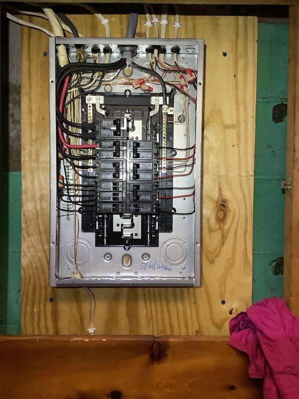Completed 100-amp electrical service upgrade including installation of exterior disconnect switch as mandated by 2023 National Electrical Code requirements. Upgraded main service panel with new circuit breakers, installed proper grounding system with bonding connections, and ran new service conductors from exterior disconnect to interior distribution panel. All work performed to code specifications with high-amperage terminal connections, neutral bus bars properly configured, and exterior weatherproof enclosure mounted on building exterior with PVC conduit entry.