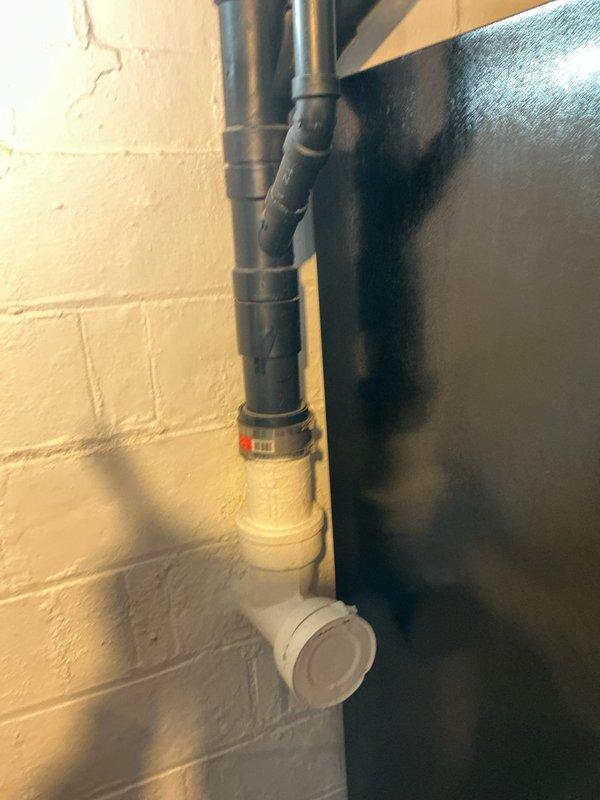 Responded to main drain backup with slow drainage issue. Upon arrival, located main drain cleanout access point in basement utility area near water heater. Performed thorough inspection of drainage system and cleanout assembly. Successfully cleared main drain line obstruction using professional drain cleaning equipment. Verified proper flow and drainage restored to system. Tested multiple fixtures to confirm blockage eliminated and drainage operating at normal capacity.