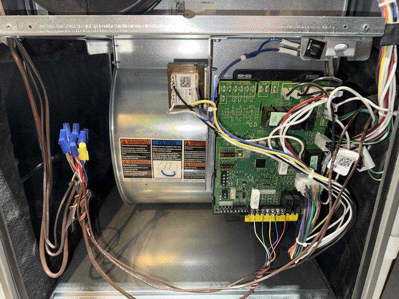 Completed MVP recurring cooling maintenance visit. Upon inspection, discovered evaporator coil with extensive frost buildup indicating potential airflow restriction or refrigerant issue. Documented control board configuration and electrical connections within equipment enclosure, noting multiple circuit boards and wiring harness in proper condition. Photographed refrigerant line set showing insulated copper piping with brass fittings and some surface corrosion on metal components. System control panel and transformer housing displayed appropriate warning labels and appeared operational.