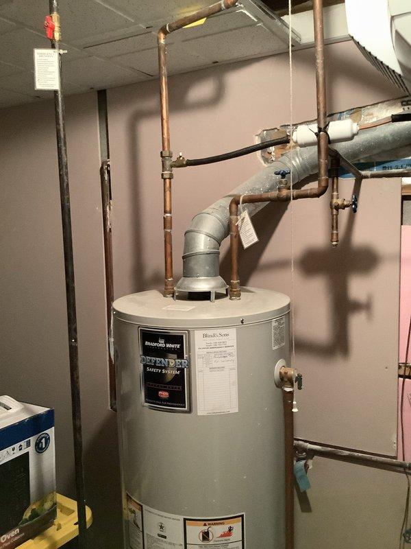 Responded to customer request for water heater replacement quote. Inspected existing 12-year-old Bradford White 50-gallon natural gas tank water heater, model M1503S6BN with 40,000 BTU/hr input capacity. Documented current installation including copper and galvanized piping configuration, venting system, and overall equipment condition. Photographed manufacturer data plate showing serial number and specifications, as well as complete installation setup to provide accurate assessment for replacement options. Provided customer with information regarding both traditional tank-style and tankless water heater alternatives based on existing system evaluation.