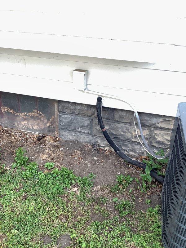 Conducted on-site assessment for HVAC system replacement at residential property with 19-year-old existing equipment. Evaluated current Goodman furnace installation in basement mechanical room, noting PVC venting configuration and refrigerant line routing. Documented exterior conditions including deteriorated foundation barrier material near outdoor condensing unit location, with significant damage requiring attention during replacement installation. Photographed existing system components and site conditions to prepare comprehensive replacement estimate for complete HVAC system upgrade.