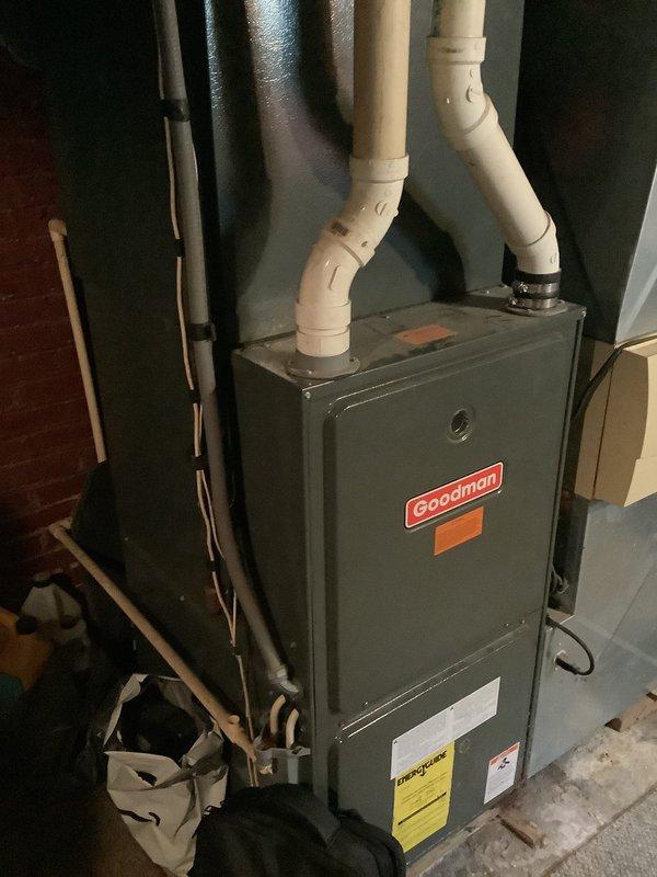 Conducted on-site assessment for HVAC system replacement at residential property with 19-year-old existing equipment. Evaluated current Goodman furnace installation in basement mechanical room, noting PVC venting configuration and refrigerant line routing. Documented exterior conditions including deteriorated foundation barrier material near outdoor condensing unit location, with significant damage requiring attention during replacement installation. Photographed existing system components and site conditions to prepare comprehensive replacement estimate for complete HVAC system upgrade.