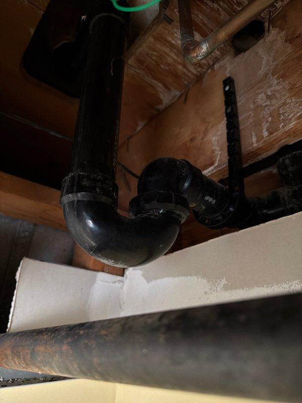 Replaced deteriorated bathtub waste and overflow assembly with new lift-and-turn style unit due to failed gaskets causing intermittent leaking from overflow. Removed existing union-style trap beneath tub and installed permanent glued PVC trap with new trap adapter to eliminate potential leak points and ensure proper drainage. Parts were coordinated through shop for timely completion of repair work.