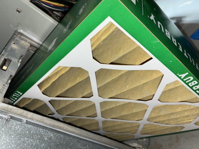 Performed routine maintenance on 13-year-old air conditioning system. Inspected air filter and found it in good condition with minimal debris accumulation. Evaluated evaporator coil and heat exchanger fins, noting some dust buildup but components remain operational. Assessed ductwork for potential cleaning needs and documented system condition with photos for customer records.