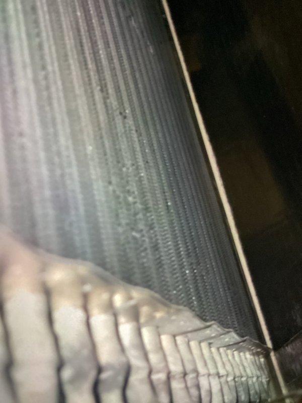 Completed annual cooling maintenance on residential air conditioning system. Performed inspection of evaporator coil and condenser coil fins, verified proper operation of electrical components including dual 40-amp Littelfuse fuses in disconnect, and documented equipment condition through photographic records. All components found operating within normal parameters with routine dust accumulation noted on coil surfaces.
