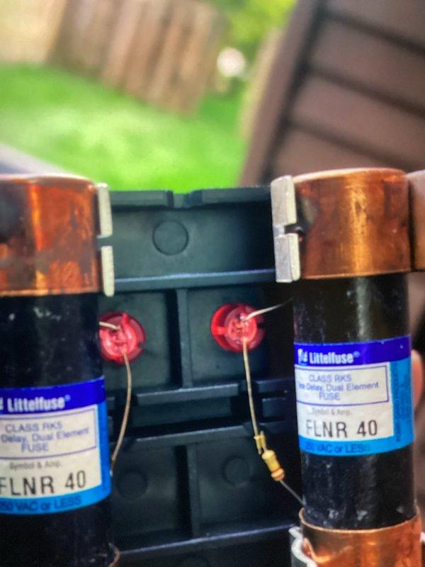 Completed annual cooling maintenance on residential air conditioning system. Performed inspection of evaporator coil and condenser coil fins, verified proper operation of electrical components including dual 40-amp Littelfuse fuses in disconnect, and documented equipment condition through photographic records. All components found operating within normal parameters with routine dust accumulation noted on coil surfaces.