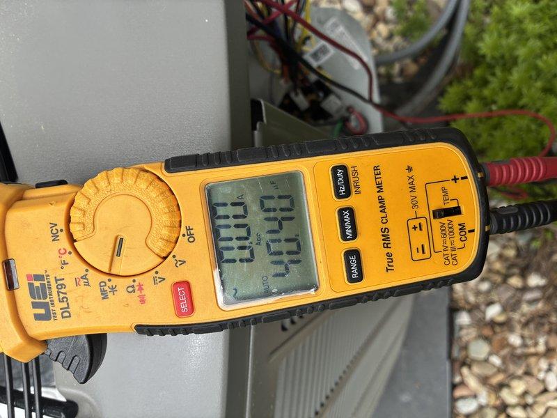 Completed preventive maintenance on 2-year-old air conditioning system. Performed electrical diagnostics using digital multimeter, verifying voltage readings and system performance at 27.5V on measured circuit. Inspected all electrical components within control panel including capacitor, wiring connections, and terminal blocks. All connections found secure with proper color-coded wiring intact. System operating within normal parameters with no deficiencies noted.