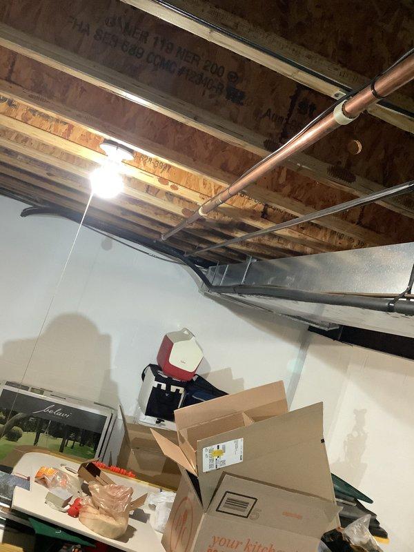 Conducted on-site HVAC system evaluation for replacement estimate on 30-year-old existing equipment. Assessed indoor air handler installation in unfinished basement area with exposed ceiling joists and existing ductwork, as well as outdoor condensing unit positioned on exterior pad adjacent to structure. Documented current system configuration, equipment specifications, and installation requirements through comprehensive site photography to prepare detailed replacement quotation for complete HVAC system upgrade.