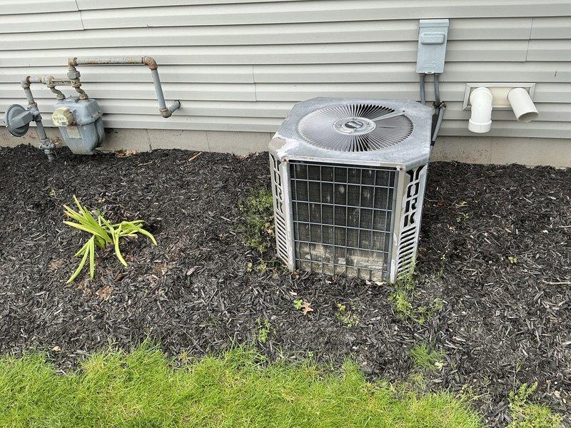 Completed comprehensive HVAC estimate for furnace and air conditioning replacement at duplex property. Assessed existing outdoor condenser unit showing weathering and age, along with associated electrical disconnect and gas meter configuration. Evaluated basement ductwork system including metal plenum and distribution components for compatibility with proposed replacement equipment.