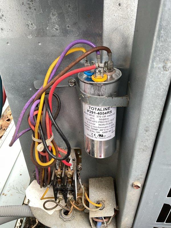 # HVAC Service Completed

Responded to a no-cooling complaint where the air conditioning system was running continuously without producing cool air. Upon inspection, identified a failed dual-run capacitor (Totaline P291-4054RS) showing visible signs of corrosion and deterioration on the terminals and housing. The defective capacitor was preventing the compressor and condenser fan motor from operating at proper capacity, resulting in the system running but failing to cool. Replaced the failed capacitor with a new unit matching the required specifications for voltage and microfarad ratings. Verified all electrical connections at the contactor and terminal blocks were secure. Tested system operation and confirmed compressor and condenser fan motor startup, proper amperage draw, and return to normal cooling function. System now cycling properly and delivering adequate cooling to the conditioned space.