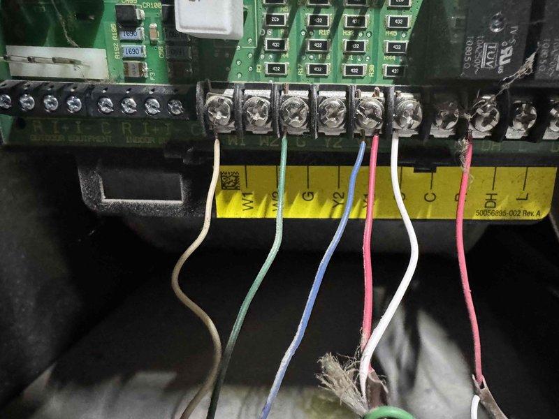 Responded to no cooling call on 4-year-old air conditioning system. Upon arrival, verified unit was not powering on. Inspected thermostat wiring connections and control board assembly. Found issue with low voltage wiring at thermostat terminal block affecting system communication. Corrected wiring connections at thermostat base, ensuring proper C-wire and W-wire terminations per manufacturer specifications. Verified all wire connections at control board terminal strip were secure. Cycled system power and confirmed unit now responding to thermostat calls properly. System operational at time of departure.