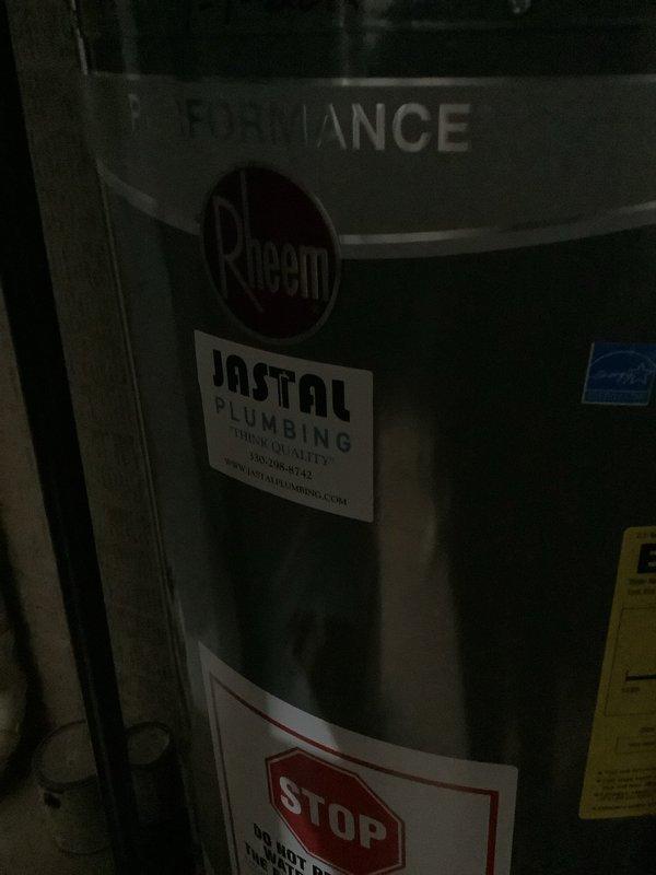 Responded to service call for 5-year-old Rheem natural gas water heater producing only lukewarm water and exhibiting minor leak from bottom of unit. Upon inspection, documented unit condition with photographs showing manufacturer labels, installation information from Jastal Plumbing, and energy guide specifications. Assessed water heater for potential warranty coverage as requested, examining unit age and symptoms to determine eligibility for manufacturer warranty claim. Leak observed at base of tank indicates possible internal tank failure, which would be covered under typical manufacturer warranty terms for a unit of this age.