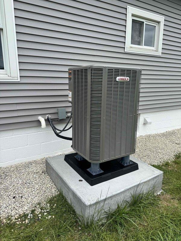 Completed full HVAC system replacement installing a new Lennox dual fuel heat pump condenser unit on an existing concrete pad with proper leveling and mounting. Installed new refrigerant line set with insulation and white PVC condensate drain, properly secured and routed into the residence through the exterior wall. Connected electrical conduit from outdoor unit to house, ensuring all connections meet code requirements for dual fuel operation with propane heating system.