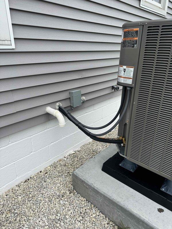 Completed full HVAC system replacement installing a new Lennox dual fuel heat pump condenser unit on an existing concrete pad with proper leveling and mounting. Installed new refrigerant line set with insulation and white PVC condensate drain, properly secured and routed into the residence through the exterior wall. Connected electrical conduit from outdoor unit to house, ensuring all connections meet code requirements for dual fuel operation with propane heating system.