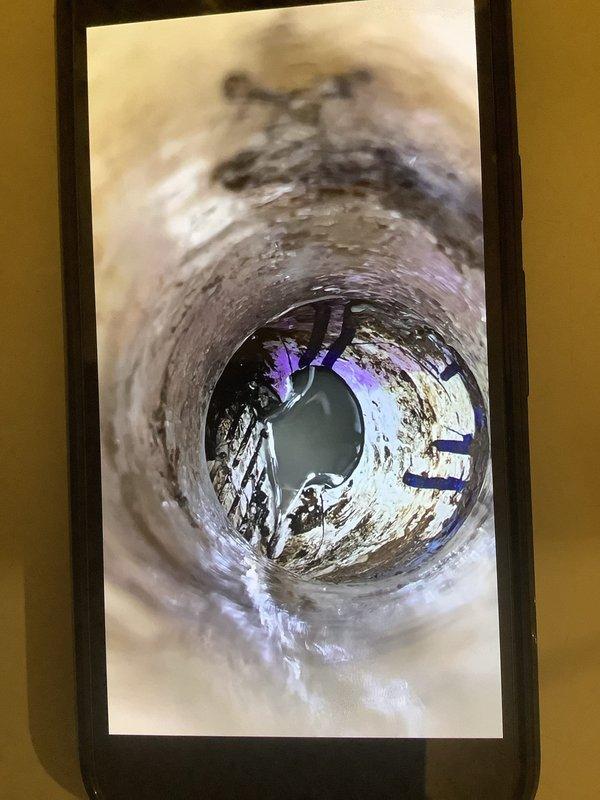 Performed second opinion evaluation of furnace condensate drain line system requiring repair. Conducted camera inspection of drain line to assess condition and feasibility of trenchless repair options due to concrete floor installation. Documented interior condition of drain line showing corrosion, discoloration, and buildup, and provided recommendations for repair approach that would minimize disruption to concrete flooring.