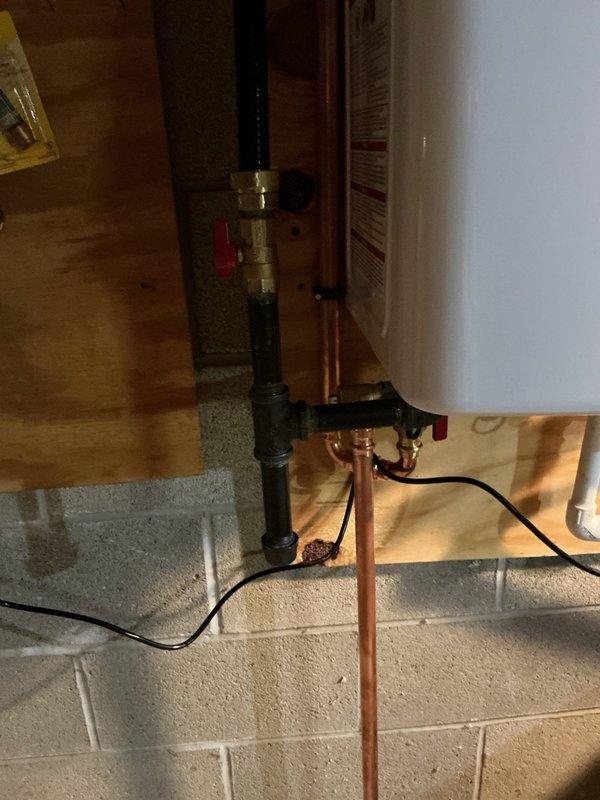 Removed existing Rheem tank-style water heater and installed new Navien tankless water heating unit on exterior wall adjacent to electrical panel. Relocated and rerouted water supply lines and gas lines to new unit location, connecting to existing system at optimal connection points. Installed condensate drain line from tankless unit to existing sump pump to handle moisture discharge. Coordinated electrical work to provide dedicated 120V outlet for unit operation. Installed PVC intake and exhaust venting through exterior wall with proper termination and weatherproofing per manufacturer specifications. Tested all connections for leaks, verified proper gas pressure, confirmed electrical supply, and commissioned unit for operation. Unit backed by 5-year parts warranty and 15-year heat exchanger warranty.