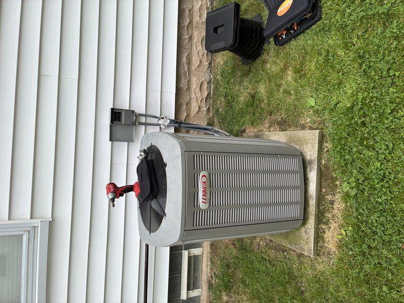 Completed scheduled BS-MVP cooling maintenance visit on Lennox air conditioning system. Upon arrival, performed comprehensive system inspection including visual examination of outdoor condenser unit, electrical disconnect switch, and refrigerant line connections. Verified electrical disconnect box operational with switch in ON position and confirmed proper connection integrity. Inspected condenser unit exterior condition, fan assembly operation, and refrigerant line insulation. All components found to be functioning within normal parameters with no immediate service needs identified. Documentation photos captured of electrical disconnect and outdoor condenser unit for service records.