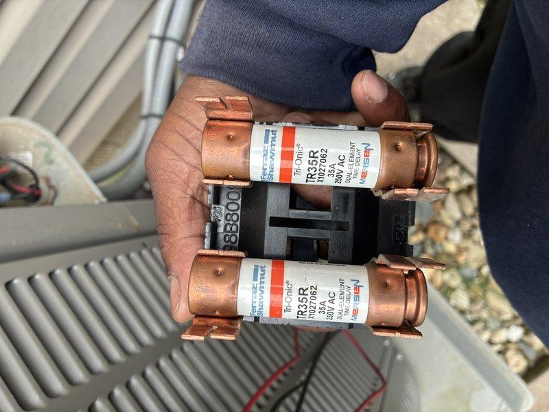 Completed preventive maintenance on 6-year-old air conditioning system, including inspection of electrical components and outdoor unit. Verified proper operation of TR35R 600VAC 35A fuses in disconnect box, confirmed all electrical connections secure, and inspected condenser coil condition. System operating within normal parameters following routine maintenance procedures.
