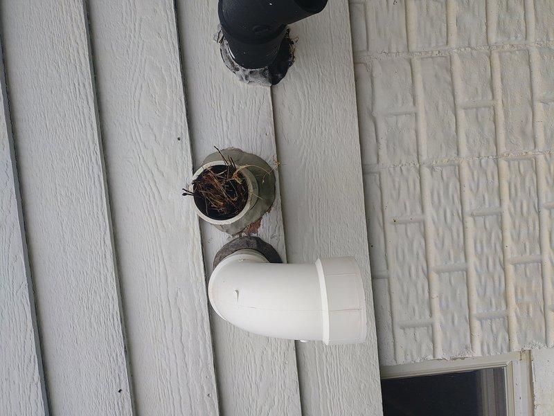 Responded to service call for furnace displaying blinking red error light. Upon inspection, discovered furnace condensate drain line severely obstructed with debris and nesting material at exterior termination point. Cleared blockage from PVC condensate drain assembly, including exterior vent opening and interior piping connections in attic space. Verified proper drainage flow, tested furnace operation, and confirmed error code cleared. System restored to normal operation with proper condensate removal functioning.