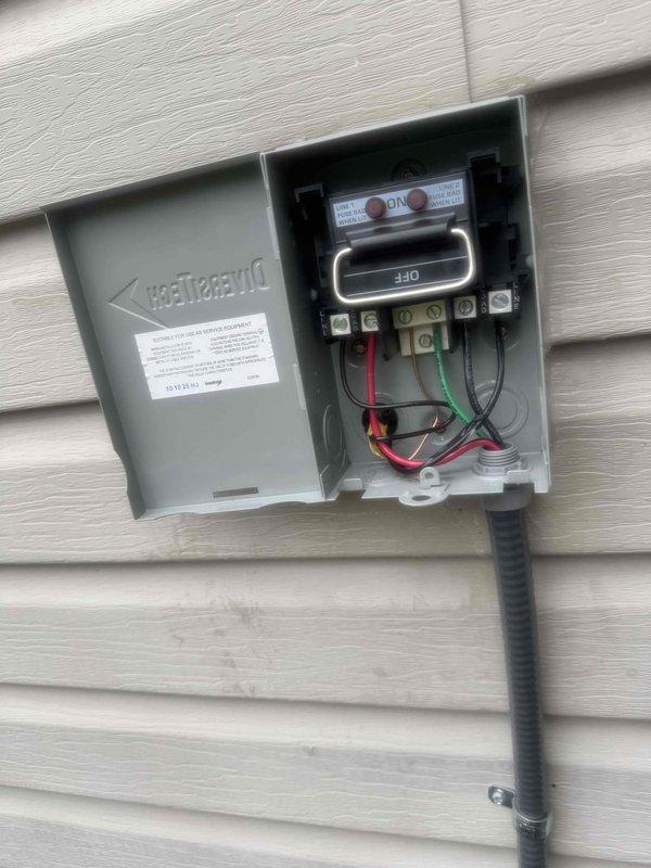 Completed AC circuit pre-wire installation over multiple site visits. Installed and configured main electrical panel in interior stairwell location, mounting breaker box with dual columns of circuit breakers and proper labeling. Established branch circuit wiring with outlet installations at appropriate wall heights below panel. Applied non-slip safety treads to stairwell steps in work area. Installed exterior disconnect box on building siding with ON/OFF switch mechanism, connecting service conductors through conduit entry. Terminated red, black, and green phase and ground wiring to terminal blocks with proper torque specifications. Routed flexible conduit from disconnect enclosure down exterior wall for service connection. All installations completed per NEC requirements with appropriate wire sizing and connection methods.