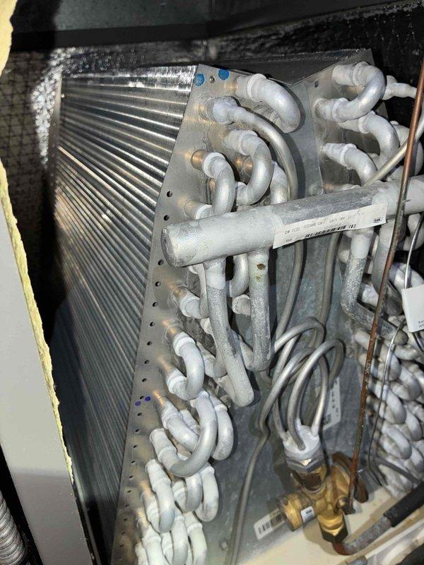 Completed comprehensive A/C tune-up service including full system inspection and maintenance. Installed customer-provided filter into humidifier system and provided complimentary carbon monoxide detector. Inspected evaporator coil assembly, refrigerant lines, and all system components; all equipment found to be in operational condition with normal wear patterns consistent with regular use.