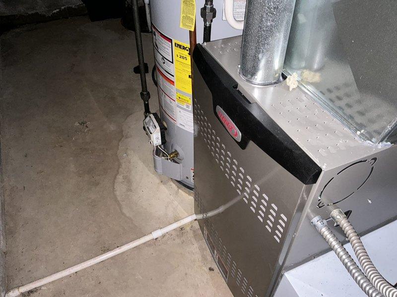 Provided comprehensive estimate for complete HVAC system replacement on aging 26-year-old residential heating and cooling equipment. Assessment included evaluation of existing basement-installed furnace unit with perforated front panel and exterior air conditioning condenser unit showing significant weathering, dirt accumulation, and surface wear consistent with end-of-service-life condition. Documented current system configuration including ductwork connections, electrical conduit routing, and equipment placement for accurate replacement specifications and installation planning.
