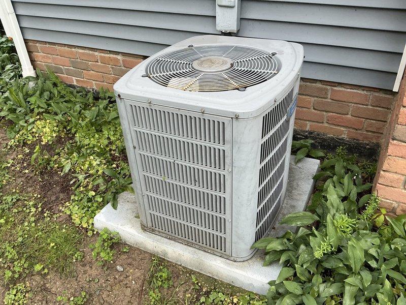 Provided comprehensive estimate for complete HVAC system replacement on aging 26-year-old residential heating and cooling equipment. Assessment included evaluation of existing basement-installed furnace unit with perforated front panel and exterior air conditioning condenser unit showing significant weathering, dirt accumulation, and surface wear consistent with end-of-service-life condition. Documented current system configuration including ductwork connections, electrical conduit routing, and equipment placement for accurate replacement specifications and installation planning.