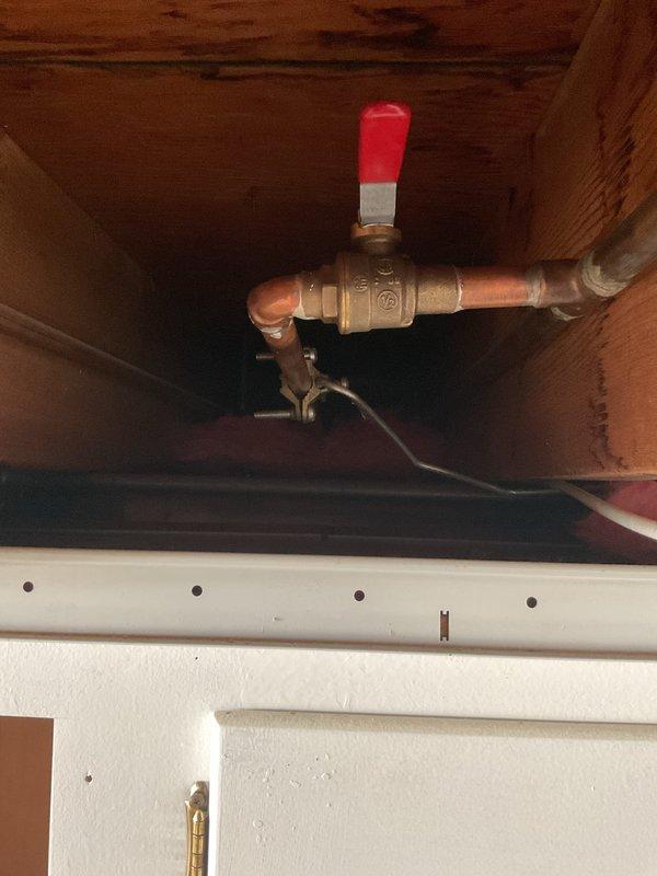 Responded to no-flow condition at backyard hose spigot. Upon inspection, identified closed ball valve in crawlspace supply line serving exterior fixture. Opened brass ball valve by rotating red handle to operational position, restoring water flow to outdoor spigot. Verified proper operation and full water pressure at hose bib upon completion.