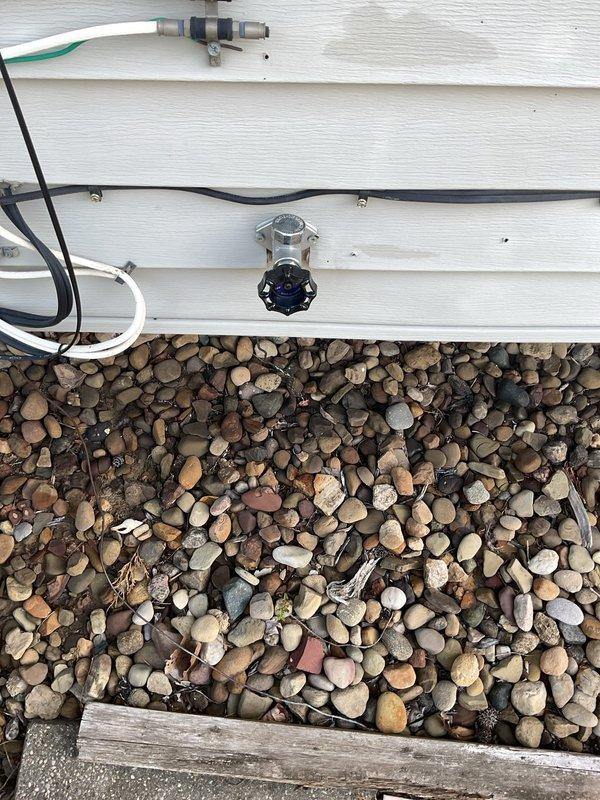 Responded to no-flow condition at backyard hose spigot. Upon inspection, identified closed ball valve in crawlspace supply line serving exterior fixture. Opened brass ball valve by rotating red handle to operational position, restoring water flow to outdoor spigot. Verified proper operation and full water pressure at hose bib upon completion.