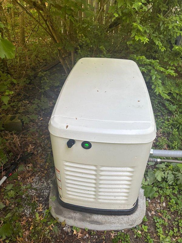 Performed routine maintenance on residential standby generator unit. Inspected generator system, confirmed operational status with green indicator light showing normal operation. Replaced air filters as part of scheduled maintenance service. Verified all ventilation louvers clear of debris, inspected external housing condition, and confirmed proper placement on concrete pad. System tested and operating within normal parameters upon completion of service.