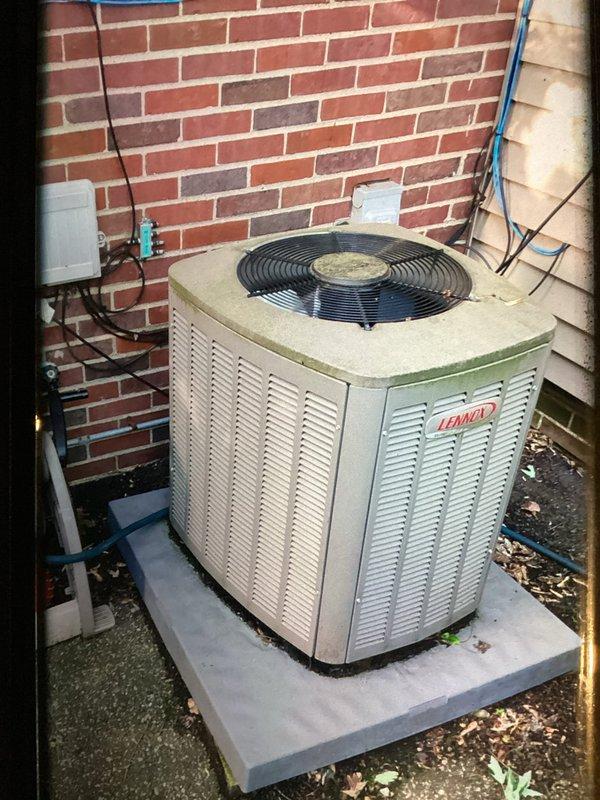 Completed scheduled maintenance visit on a 4-year-old Lennox air conditioning system. Performed comprehensive cooling system inspection including examination of outdoor condensing unit, refrigerant lines, electrical connections, and indoor furnace components. Condensing unit showed normal wear with some surface discoloration and debris accumulation; cleaned fan assembly and exterior surfaces. Verified proper operation of all mechanical and electrical components, checked refrigerant line connections, and inspected burner assembly and associated wiring inside the air handler. System operating within normal parameters with no immediate service needs identified.